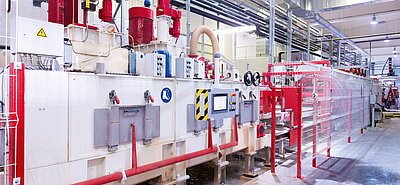 SR SCHINDLER calibrating line with enclosed modules and safety fencing for precise calibration of concrete products.