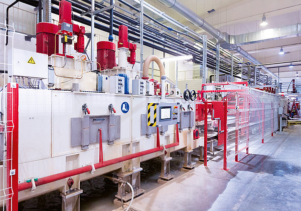 SR SCHINDLER calibrating line with enclosed modules and safety fencing for precise calibration of concrete products.
