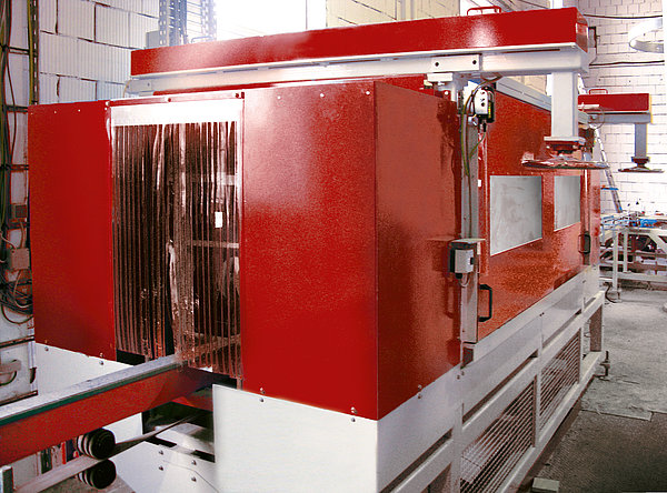 SR SCHINDLER edge breaking machine with enclosed housing for controlled finishing of concrete product edges.
